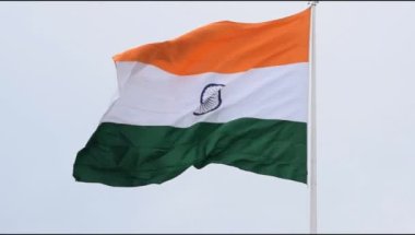 India flag flying high at Connaught Place with pride in blue sky, India flag fluttering, Indian Flag on Independence Day and Republic Day of India, tilt up shot, Waving Indian flag, Har Ghar Tiranga