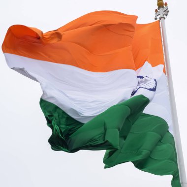 India flag flying high at Connaught Place with pride in blue sky, India flag fluttering, Indian Flag on Independence Day and Republic Day of India, tilt up shot, Waving Indian flag, Har Ghar Tiranga