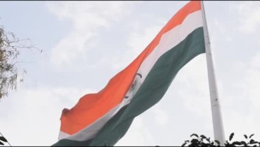 India flag flying high at Connaught Place with pride in blue sky, India flag fluttering, Indian Flag on Independence Day and Republic Day of India, tilt up shot, Waving Indian flag, Har Ghar Tiranga