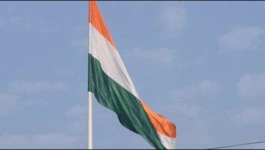 India flag flying high at Connaught Place with pride in blue sky, India flag fluttering, Indian Flag on Independence Day and Republic Day of India, tilt up shot, Waving Indian flag, Har Ghar Tiranga