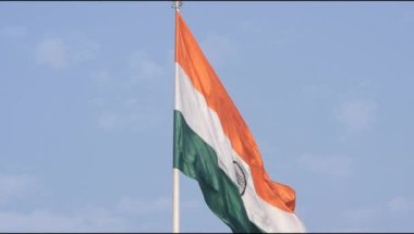 India flag flying high at Connaught Place with pride in blue sky, India flag fluttering, Indian Flag on Independence Day and Republic Day of India, tilt up shot, Waving Indian flag, Har Ghar Tiranga