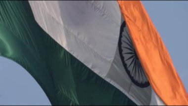 India flag flying high at Connaught Place with pride in blue sky, India flag fluttering, Indian Flag on Independence Day and Republic Day of India, tilt up shot, Waving Indian flag, Har Ghar Tiranga