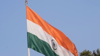 India flag flying high at Connaught Place with pride in blue sky, India flag fluttering, Indian Flag on Independence Day and Republic Day of India, tilt up shot, Waving Indian flag, Har Ghar Tiranga