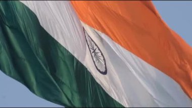 India flag flying high at Connaught Place with pride in blue sky, India flag fluttering, Indian Flag on Independence Day and Republic Day of India, tilt up shot, Waving Indian flag, Har Ghar Tiranga