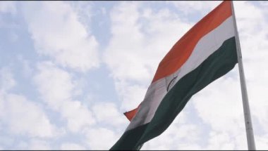 India flag flying high at Connaught Place with pride in blue sky, India flag fluttering, Indian Flag on Independence Day and Republic Day of India, tilt up shot, Waving Indian flag, Har Ghar Tiranga