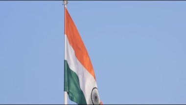 India flag flying high at Connaught Place with pride in blue sky, India flag fluttering, Indian Flag on Independence Day and Republic Day of India, tilt up shot, Waving Indian flag, Har Ghar Tiranga