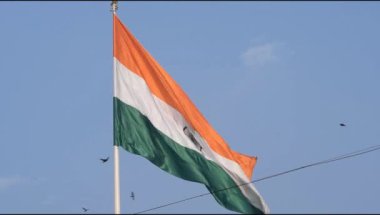 India flag flying high at Connaught Place with pride in blue sky, India flag fluttering, Indian Flag on Independence Day and Republic Day of India, tilt up shot, Waving Indian flag, Har Ghar Tiranga