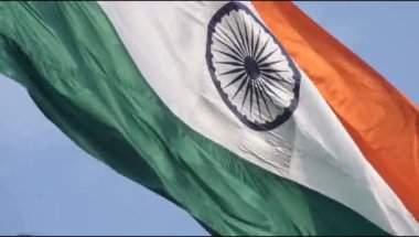 India flag flying high at Connaught Place with pride in blue sky, India flag fluttering, Indian Flag on Independence Day and Republic Day of India, tilt up shot, Waving Indian flag, Har Ghar Tiranga