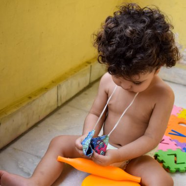 Şirin küçük çocuk Shivaay Sapra yaz zamanı evde balkonda, tatlı küçük çocuk gün ışığında fotoşop, küçük çocuk fotoğraf çekimi sırasında evde eğleniyor.
