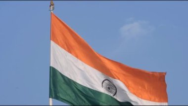 India flag flying high at Connaught Place with pride in blue sky, India flag fluttering, Indian Flag on Independence Day and Republic Day of India, tilt up shot, Waving Indian flag, Har Ghar Tiranga