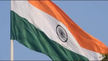 India flag flying high at Connaught Place with pride in blue sky, India flag fluttering, Indian Flag on Independence Day and Republic Day of India, tilt up shot, Waving Indian flag, Har Ghar Tiranga