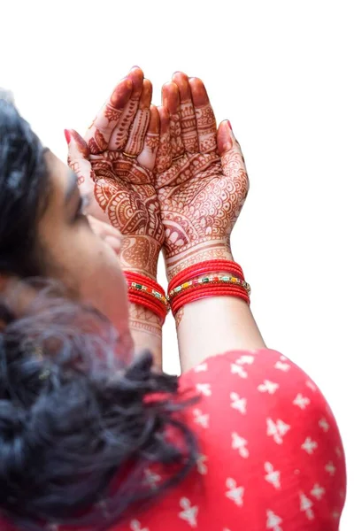 Beautiful woman dressed up as Indian tradition with henna mehndi design on her both hands to celebrate big festival of Karwa Chauth with plain white background