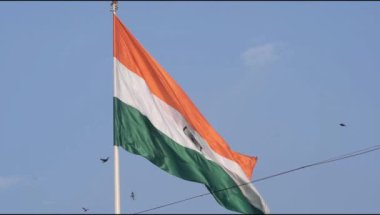 Slow-motion of India flag flying high at Connaught Place with pride in blue sky, India flag fluttering on Independence Day and Republic Day of India, Waving Indian flag, Flying India flag