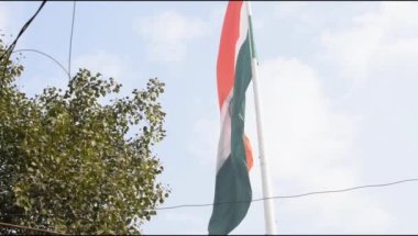 Slow-motion of India flag flying high at Connaught Place with pride in blue sky, India flag fluttering on Independence Day and Republic Day of India, Waving Indian flag, Flying India flag