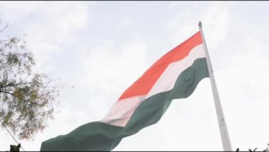 Slow-motion of India flag flying high at Connaught Place with pride in blue sky, India flag fluttering on Independence Day and Republic Day of India, Waving Indian flag, Flying India flag