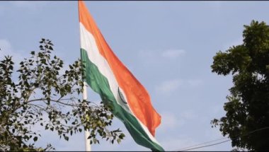 Slow-motion of India flag flying high at Connaught Place with pride in blue sky, India flag fluttering on Independence Day and Republic Day of India, Waving Indian flag, Flying India flag