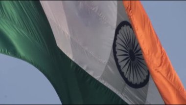 Slow-motion of India flag flying high at Connaught Place with pride in blue sky, India flag fluttering on Independence Day and Republic Day of India, Waving Indian flag, Flying India flag