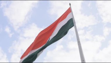 Slow-motion of India flag flying high at Connaught Place with pride in blue sky, India flag fluttering on Independence Day and Republic Day of India, Waving Indian flag, Flying India flag