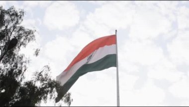 Slow-motion of India flag flying high at Connaught Place with pride in blue sky, India flag fluttering on Independence Day and Republic Day of India, Waving Indian flag, Flying India flag