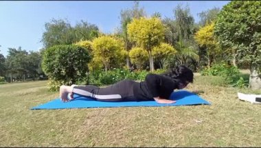Young Indian woman practicing yoga outdoor in a park. Beautiful girl practice basic yoga pose. Calmness and relax, female happiness. Basic Yoga poses outdoor 