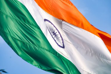 India flag flying high at Connaught Place with pride in blue sky, India flag fluttering, Indian Flag on Independence Day and Republic Day of India, tilt up shot, Waving Indian flag, Har Ghar Tiranga