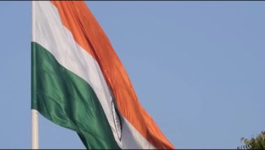 Slow-motion of India flag flying high at Connaught Place with pride in blue sky, India flag fluttering on Independence Day and Republic Day of India, Waving Indian flag, Flying India flag