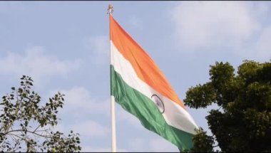 Slow-motion of India flag flying high at Connaught Place with pride in blue sky, India flag fluttering on Independence Day and Republic Day of India, Waving Indian flag, Flying India flag