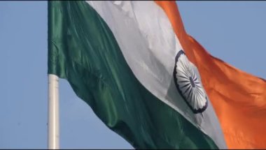 India flag flying high at Connaught Place with pride in blue sky, India flag fluttering, Indian Flag on Independence Day and Republic Day of India, tilt up shot, Waving Indian flag, Har Ghar Tiranga