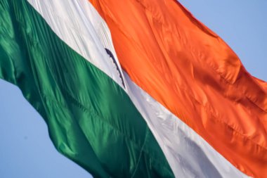 India flag flying high at Connaught Place with pride in blue sky, India flag fluttering, Indian Flag on Independence Day and Republic Day of India, tilt up shot, Waving Indian flag, Har Ghar Tiranga
