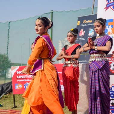 Delhi, India - December 11 2022 - Bharathanatyam Indian classical odissi dancers performing at stage. Beautiful Indian girl dancers in the posture of Indian dance. Indian classical dance Bharatanatyam