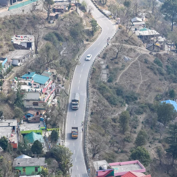 Stock image Aerial top view of traffic vehicles driving at mountains roads at Nainital, Uttarakhand, India, View from the top side of mountain for movement of traffic vehicles