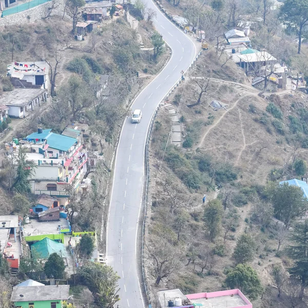 stock image Aerial top view of traffic vehicles driving at mountains roads at Nainital, Uttarakhand, India, View from the top side of mountain for movement of traffic vehicles