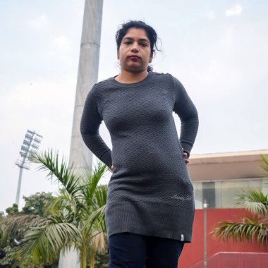 Young Indian woman practicing yoga outdoor in a park. Beautiful girl practice basic yoga pose. Calmness and relax, female happiness. Basic Yoga poses outdoor