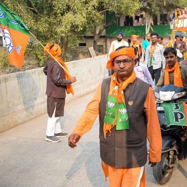 Stock image Delhi, India, December 02 2022 -Bharatiya Janata Party (BJP) supporter during mega road show in support of BJP candidate Pankaj Luthara to file nomination papers ahead of MCD local body Elections 2022