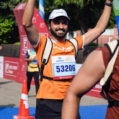 Yeni Delhi, Hindistan - 16 Ekim 2022 - Bitmek üzere olan maraton katılımcılarının bitiş çizgisini geçmek üzere olan Delhi Yarı Maratonu 2022