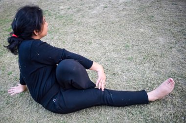 Young Indian woman practicing yoga outdoor in a park. Beautiful girl practice basic yoga pose. Calmness and relax, female happiness. Basic Yoga poses outdoor