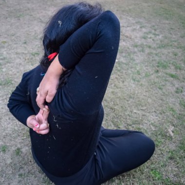 Young Indian woman practicing yoga outdoor in a park. Beautiful girl practice basic yoga pose. Calmness and relax, female happiness. Basic Yoga poses outdoor
