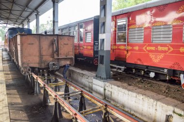View of Toy train coach from the middle of railway track during daytime near Kalka railway station in India, Toy train coach view, Indian Railway junction, Heavy industry