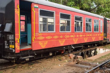 View of Toy train coach from the middle of railway track during daytime near Kalka railway station in India, Toy train coach view, Indian Railway junction, Heavy industry