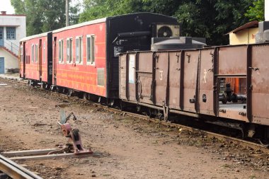 View of Toy train coach from the middle of railway track during daytime near Kalka railway station in India, Toy train coach view, Indian Railway junction, Heavy industry