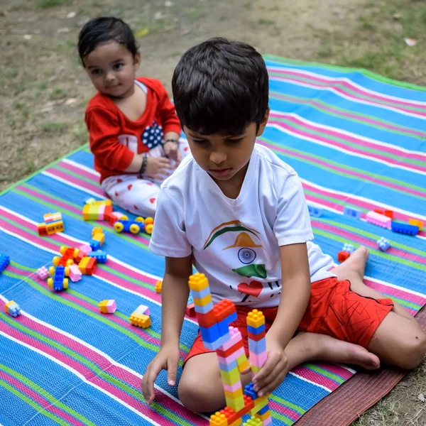 stock image Two happy boys in society park, happy Asian brothers who are smiling happily together. Brothers play outdoors in summer, best friends. Toddler baby boy playing with his happy brother in the garden