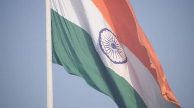 India flag flying high at Connaught Place with pride in blue sky, India flag fluttering, Indian Flag on Independence Day and Republic Day of India, tilt up shot, Waving Indian flag, Har Ghar Tiranga