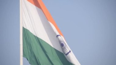 India flag flying high at Connaught Place with pride in blue sky, India flag fluttering, Indian Flag on Independence Day and Republic Day of India, tilt up shot, Waving Indian flag, Har Ghar Tiranga