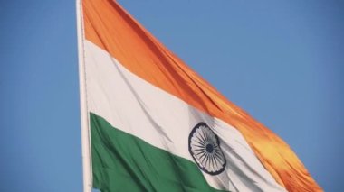 India flag flying high at Connaught Place with pride in blue sky, India flag fluttering, Indian Flag on Independence Day and Republic Day of India, tilt up shot, Waving Indian flag, Har Ghar Tiranga
