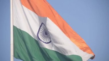 India flag flying high at Connaught Place with pride in blue sky, India flag fluttering, Indian Flag on Independence Day and Republic Day of India, tilt up shot, Waving Indian flag, Har Ghar Tiranga
