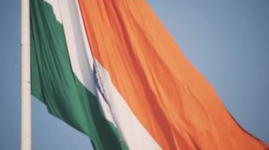 India flag flying high at Connaught Place with pride in blue sky, India flag fluttering, Indian Flag on Independence Day and Republic Day of India, tilt up shot, Waving Indian flag, Har Ghar Tiranga