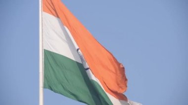 India flag flying high at Connaught Place with pride in blue sky, India flag fluttering, Indian Flag on Independence Day and Republic Day of India, tilt up shot, Waving Indian flag, Har Ghar Tiranga