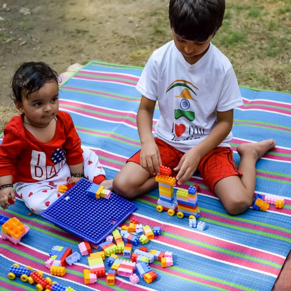 stock image Two happy boys in society park, happy Asian brothers who are smiling happily together. Brothers play outdoors in summer, best friends. Toddler baby boy playing with his happy brother in the garden