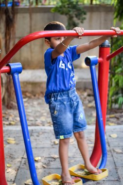 Sosyete parkında yoga pozu veren Asyalı zeki çocuk, çocuk yoga pozu. Yoga ve meditasyon yapan küçük çocuk..