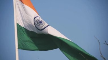 India flag flying high at Connaught Place with pride in blue sky, India flag fluttering, Indian Flag on Independence Day and Republic Day of India, tilt up shot, Waving Indian flag, Har Ghar Tiranga